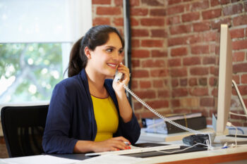 Woman Working At Computer In Contemporary Office